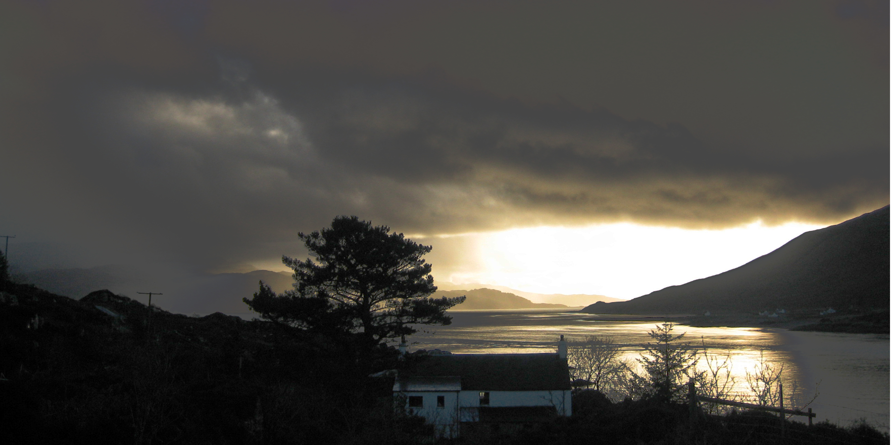 looking above ferry house across the sea at sunset